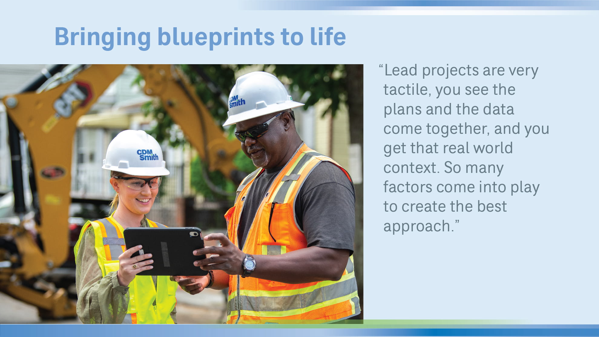 2 people on construction site looking at tablet