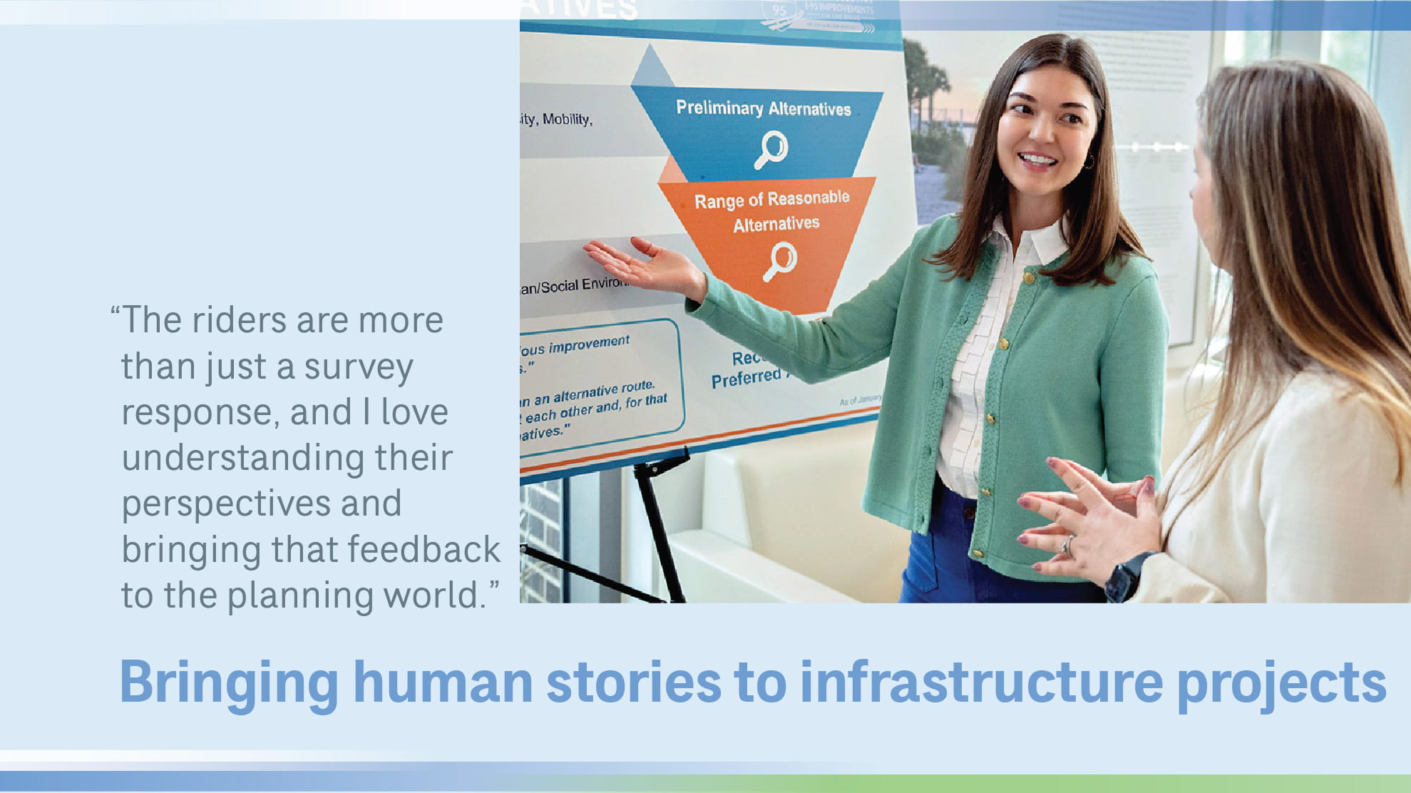 Victoria in front of a poster talking to a woman