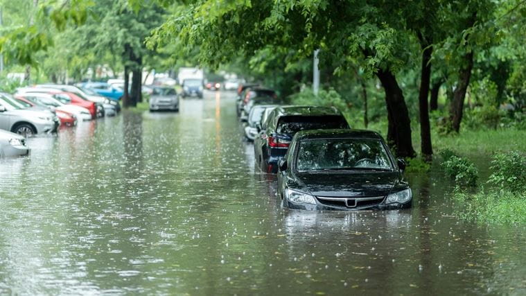 Flooded street with cars partially submerged in water