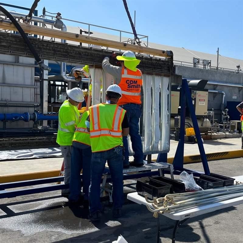 A group of CDM Smith employees assembling equipment